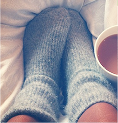Cosy picture of winter socks with a hot drink.
