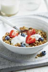 Homemade granola with natural yoghurt, strawberries and blueberries